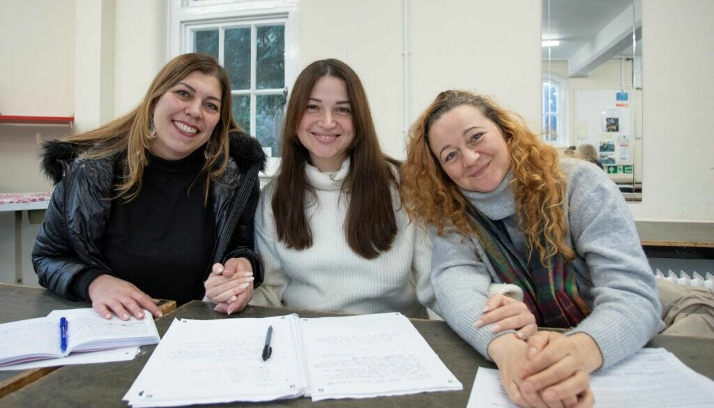 three women in an ESOL class