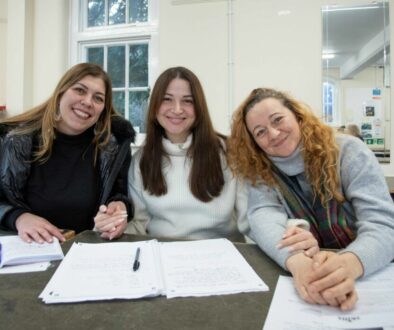 three women in an ESOL class