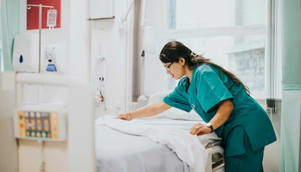 hospital worker making a hospital bed