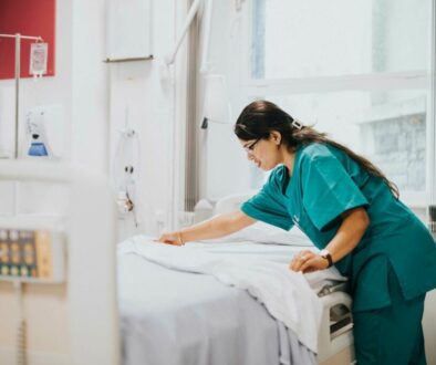 hospital worker making a hospital bed