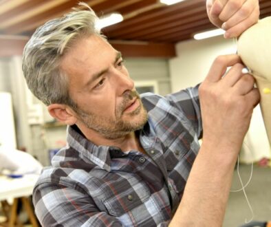 man upholstering a armchair